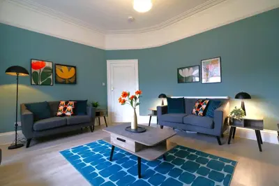 a living room with two couches and a table at Signature - St James House in Abbotsinch