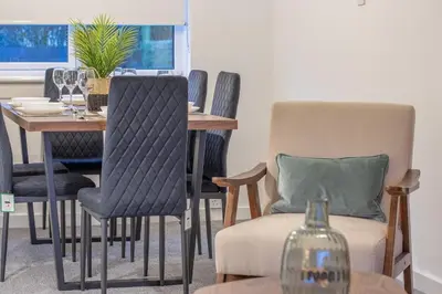 a dining room with a table and chairs at Boswell House - Modern 3 Bed House East Kilbride Close to Motorway in East Kilbride