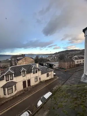 arial view of a town with cars parked on a street at The Bay View Apartment in Gourock