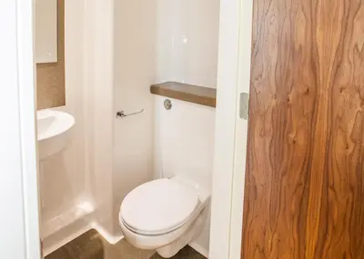 a bathroom with a white toilet and a sink at Willow Court in Stirling