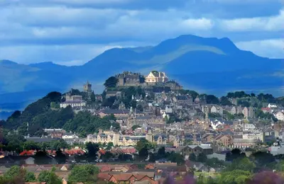 a town on a hill with mountains in the background at Willow Court in Stirling