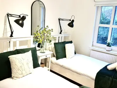 a living room with a couch and a mirror at Summerlee Gateaway in Coatbridge