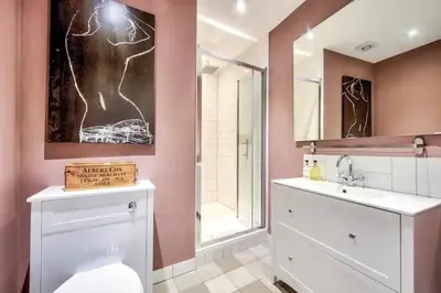 a bathroom with a toilet and a sink at Maya's Holiday Homes in Glasgow