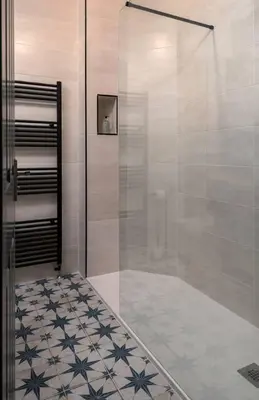 a shower with a glass door in a bathroom at The Mill Retreat in Stirling
