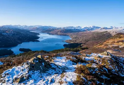 a view of a lake from the top of a mountain at 12 & 14 On the Hill Aberfoyle, twin holiday cottages in Scenic Loch Lomond & Trossachs National Park in Aberfoyle