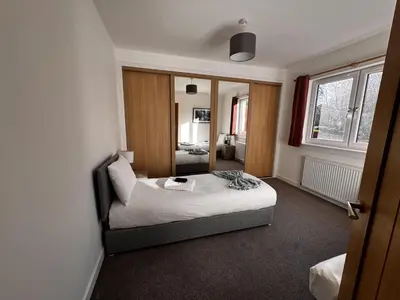 a bedroom with a bed and a mirror at Loch Ore View in Kelty