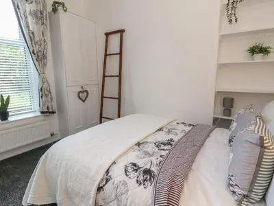 a bedroom with a bed and a ladder at Lismore in Crieff