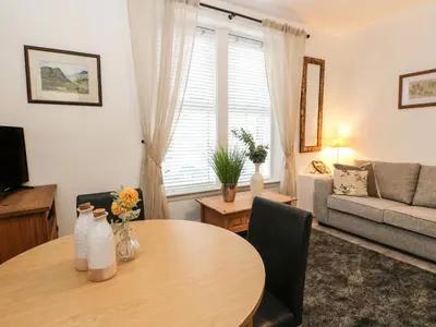 a living room with a table and a couch at Lismore in Crieff