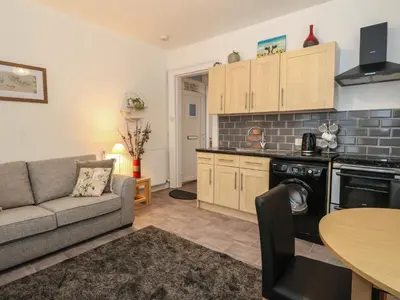 a kitchen and living room with a couch and a table at Lismore in Crieff