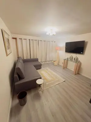 a living room with a couch and a flat screen tv at Modern & Cosy 3 Bedroom Inverkeithing home- Ideal for Edinburgh Dunfermline & St Andrews with Free Parking in Inverkeithing