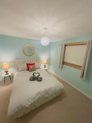 a bedroom with a bed with two slippers on it at Modern & Cosy 3 Bedroom Inverkeithing home- Ideal for Edinburgh Dunfermline & St Andrews with Free Parking in Inverkeithing