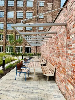 a group of benches in front of a brick building at Modern Flat in Glasgow City FREE Parking & Wifi in Glasgow