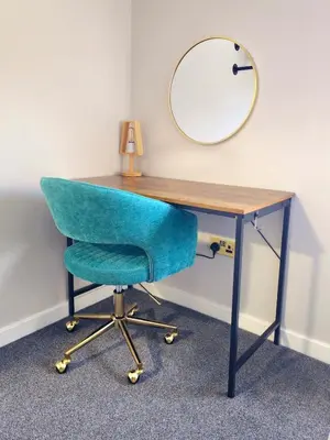 a desk with a blue chair and a mirror at Warm & Cosy Home in Glasgow in Glasgow