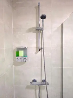 a shower in a bathroom with a glass door at Warm & Cosy Home in Glasgow in Glasgow