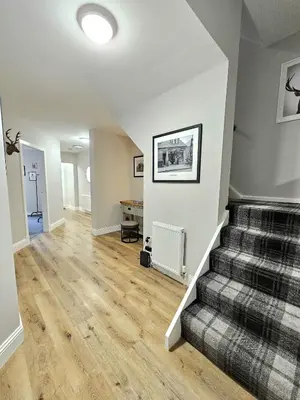 an empty living room with stairs in a house at Warm & Cosy Home in Glasgow in Glasgow