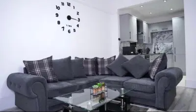 a living room with a couch and a table at Newly refurbished 2 bed ! in Glasgow