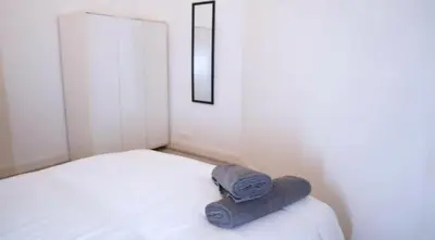 a bed with a towel sitting on top of it at Newly refurbished 2 bed ! in Glasgow