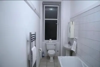 a white bathroom with a toilet and a sink at Newly refurbished 2 bed ! in Glasgow