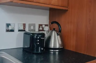 a tea kettle and toaster on a kitchen counter at 2 bed Renfield st City Center in Glasgow