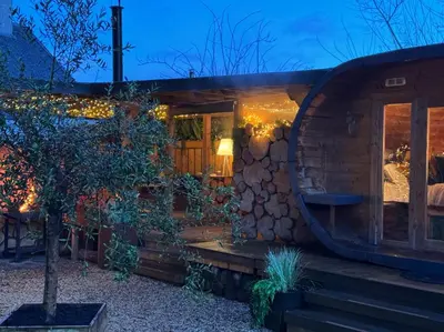 a hobbit house with a tree in front of it at Loch Lomond Hideaways- Luxury Cabins with Jacuzzi Hot Tubs for Two in Drymen