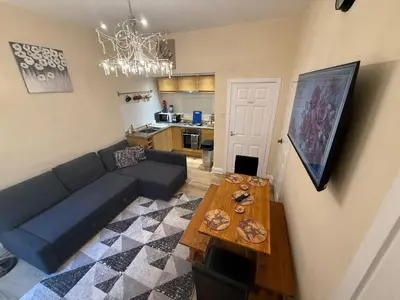 a living room with a couch and a table at Flat in Central Edinburgh Old town in Edinburgh