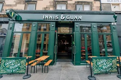 a restaurant with tables and chairs in front of it at Flat in Central Edinburgh Old town in Edinburgh