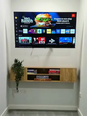 a flat screen tv hanging on a wall at 3-Bed Home in Glasgow in Glasgow