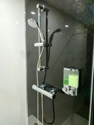 a shower in a bathroom with a mirror at 3-Bed Home in Glasgow in Glasgow