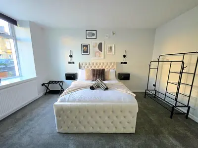 a bedroom with a large white bed in a room at 3-Bed Home in Glasgow in Glasgow