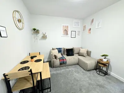 a living room with a couch and a table at 3-Bed Home in Glasgow in Glasgow