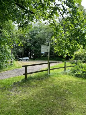 a sign on a fence next to a road at Couples Unique Stay in Bowling Club newly upgraded in Forteviot