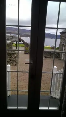a view from a door looking out at the water at Culag Lochside Self Catering in Luss