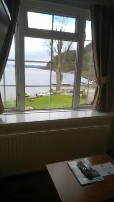 a window in a room with a view of the water at Culag Lochside Self Catering in Luss