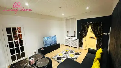 a living room with a couch and a tv at Ground Floor Entire Apartment Self Checkin in Crossgates
