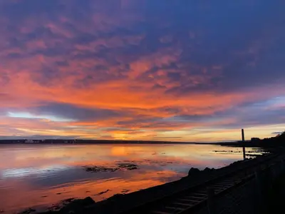 a sunset over a large body of water at A 2 Bedroom flat in Culross home of Outlander in Culross