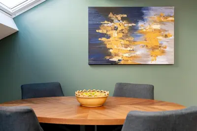 a wooden table with a bowl of fruit on it at Dragon Suites Luxury Apartments at 8 Albyn Place in Edinburgh