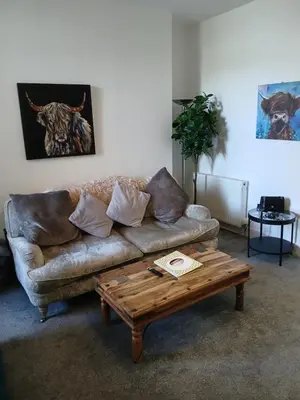 a living room with a couch and a coffee table at Sunset of Largs in Largs