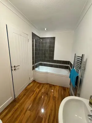 a bathroom with a bath tub and a sink at Holiday home, Carradale in Carradale