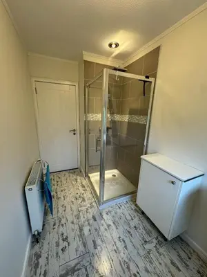 a bathroom with a shower with a glass door at Holiday home, Carradale in Carradale