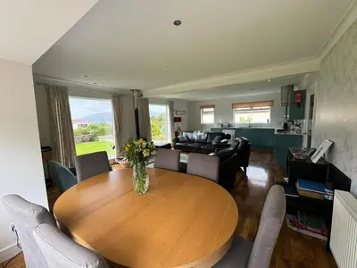 a living room with a wooden table and a couch at Holiday home, Carradale in Carradale