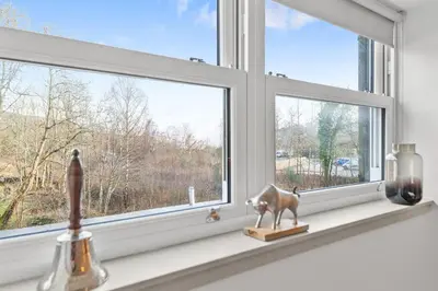 a window with a cow statue on a window sill at Luxury 3 Bedroom Cottage in Centre of Killin in Killin