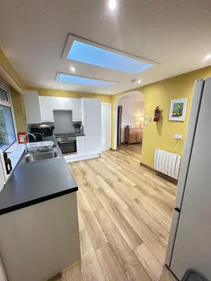 a kitchen with a sink and a counter top at Old Springwell Croft in Onich