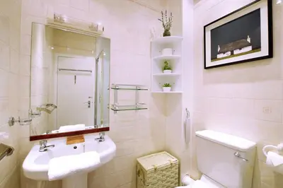 a white bathroom with a sink and a toilet at Great Location! 2BD,2 Bath in Centre of Edinburgh in Edinburgh