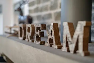 a close up of the word home spelled out in wood at Scenic Oaklodge with wood burner in Saint Fillans