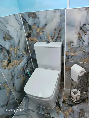 a white toilet in a bathroom with a marble wall at Double room available in Livingston