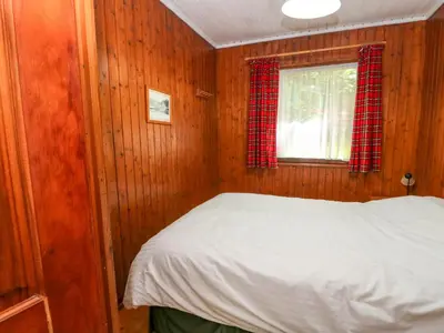 a bedroom with a bed and a window at Lodge 2 - 