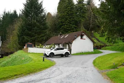 a white car parked in front of a house at Ivy Tree Cottage in Morenish
