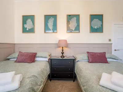 two beds sitting next to each other in a bedroom at Piersland Mews in Troon