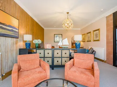 a living room with two chairs and a desk at Piersland Mews in Troon