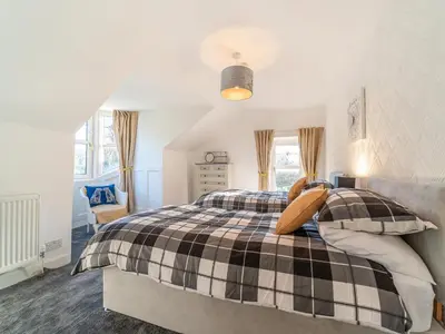 a bedroom with a black and white plaid bed at Torland in Dalserf
